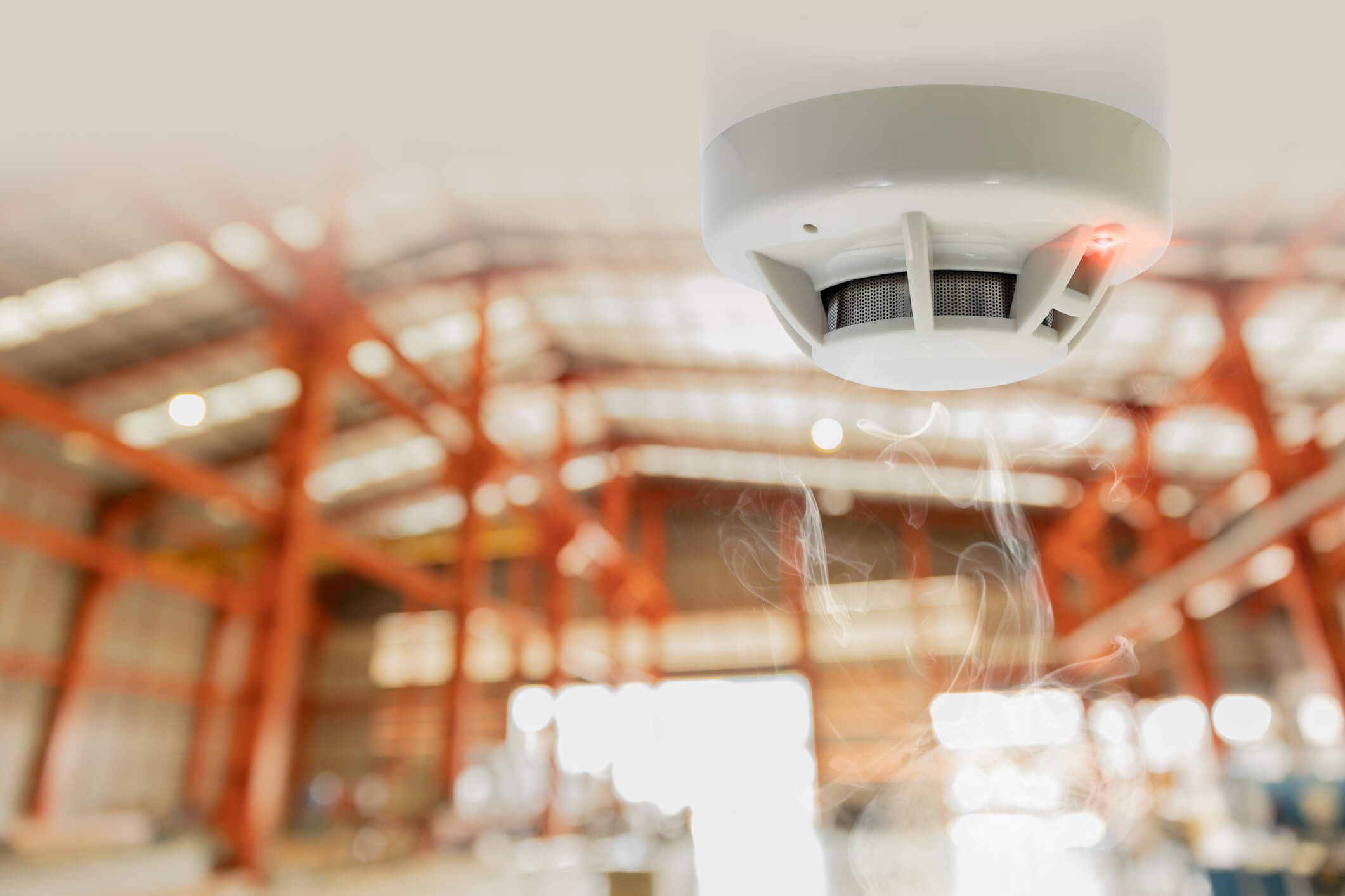 Optical beam smoke detector installed in a high-bay building